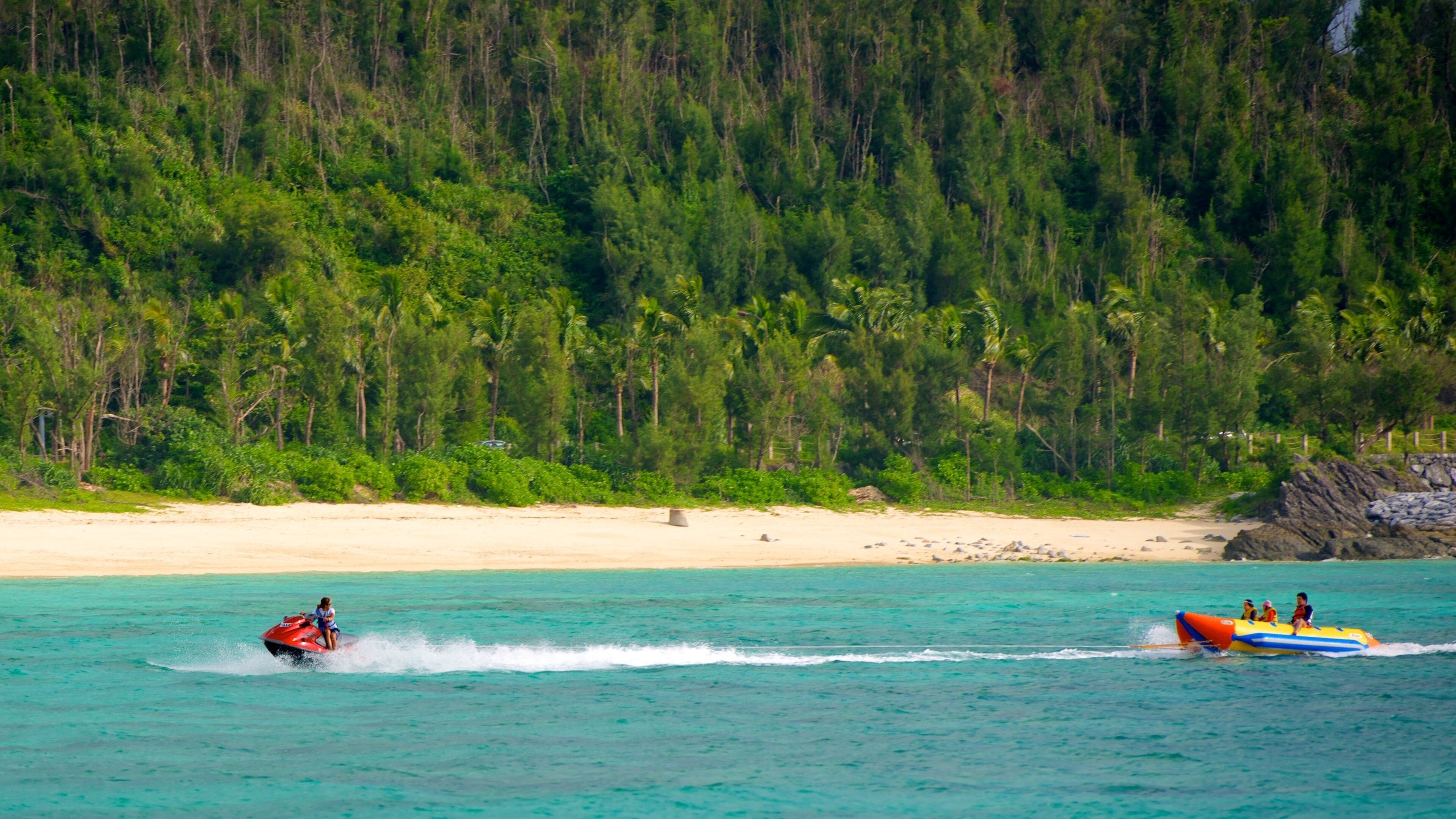 Busena Marine Park showing a beach, jet skiing and tropical scenes