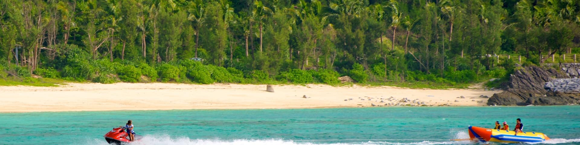 Busena Marine Park showing a beach, jet skiing and tropical scenes