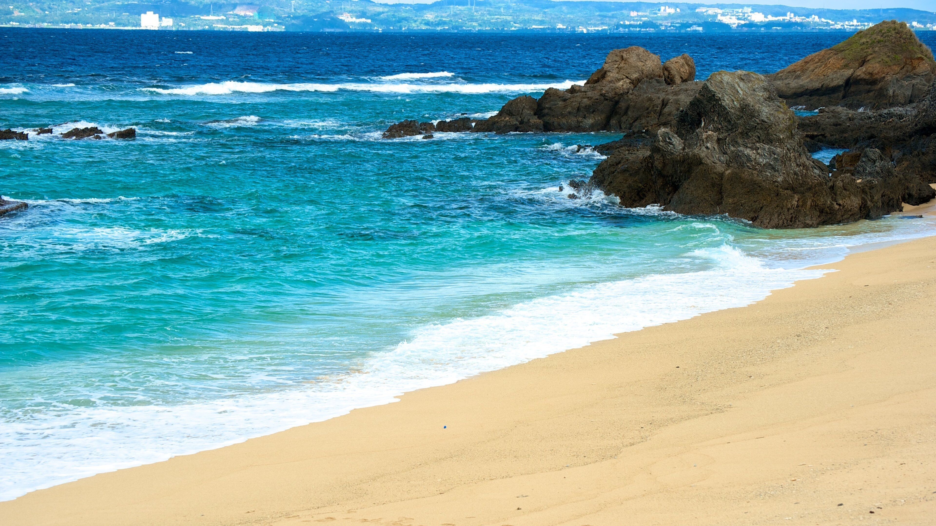 Mission Beach showing rocky coastline, a sandy beach and landscape views