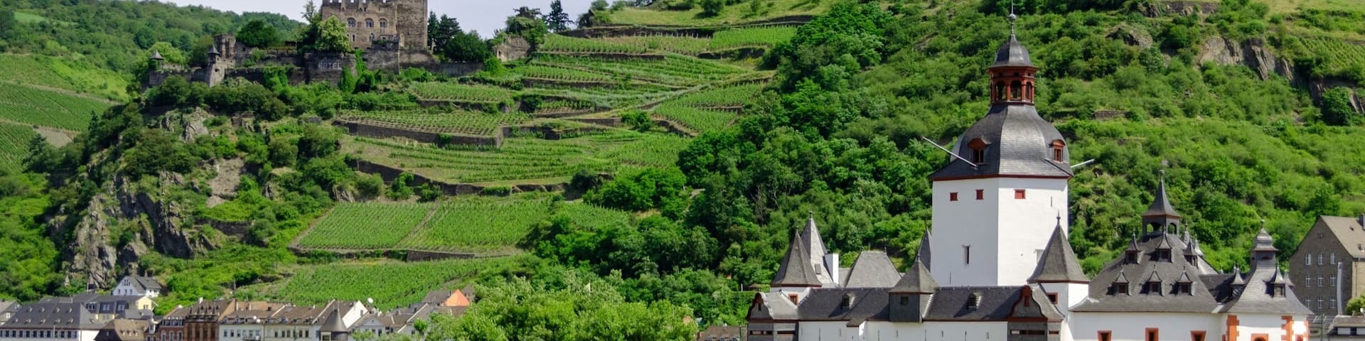 Pfalzgrafenstein Castle in the foreground is a toll castle that was erected in 1326-1327. It sits on Falkenau Island on the Rhine. Burg Gutenfels in Kaub can be seen in the distance.