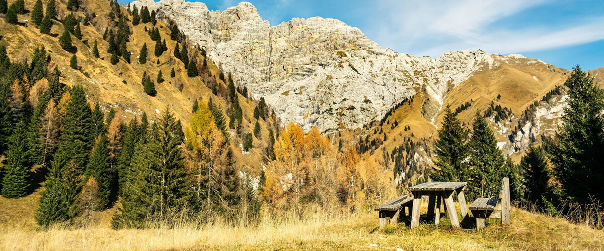 A mountainous landscape with a wooden structure in the foreground.