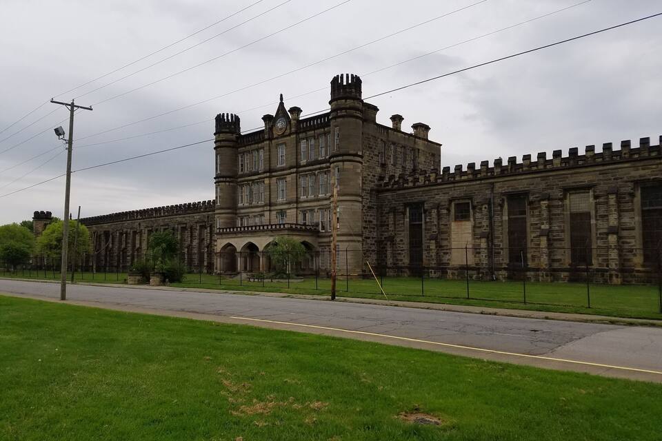 A historic stone building with multiple towers and arched windows.