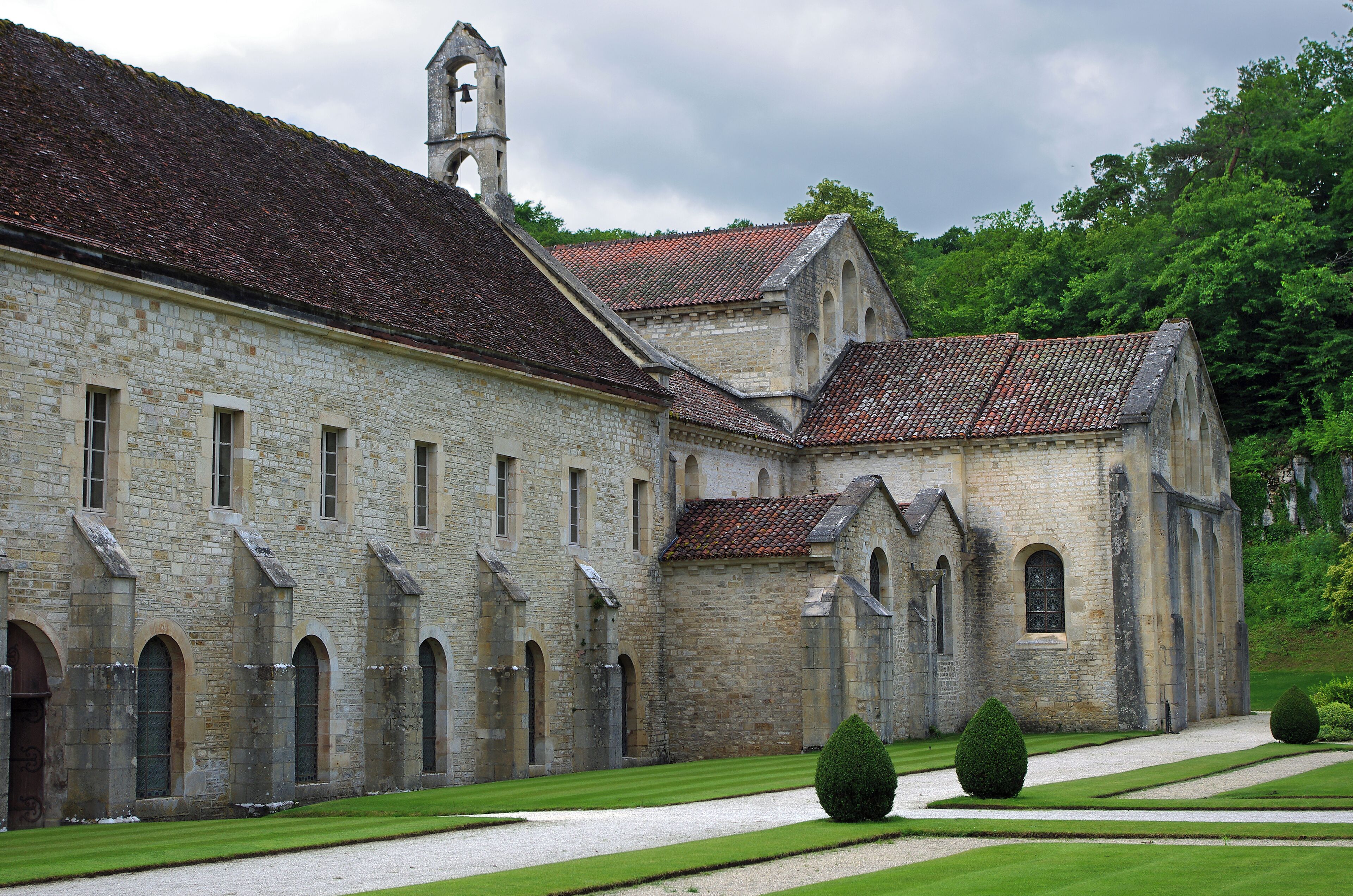A historic stone building with arched windows and a bell tower.