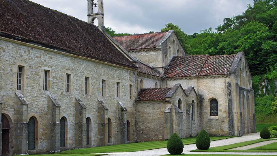 A historic stone building with arched windows and a bell tower.