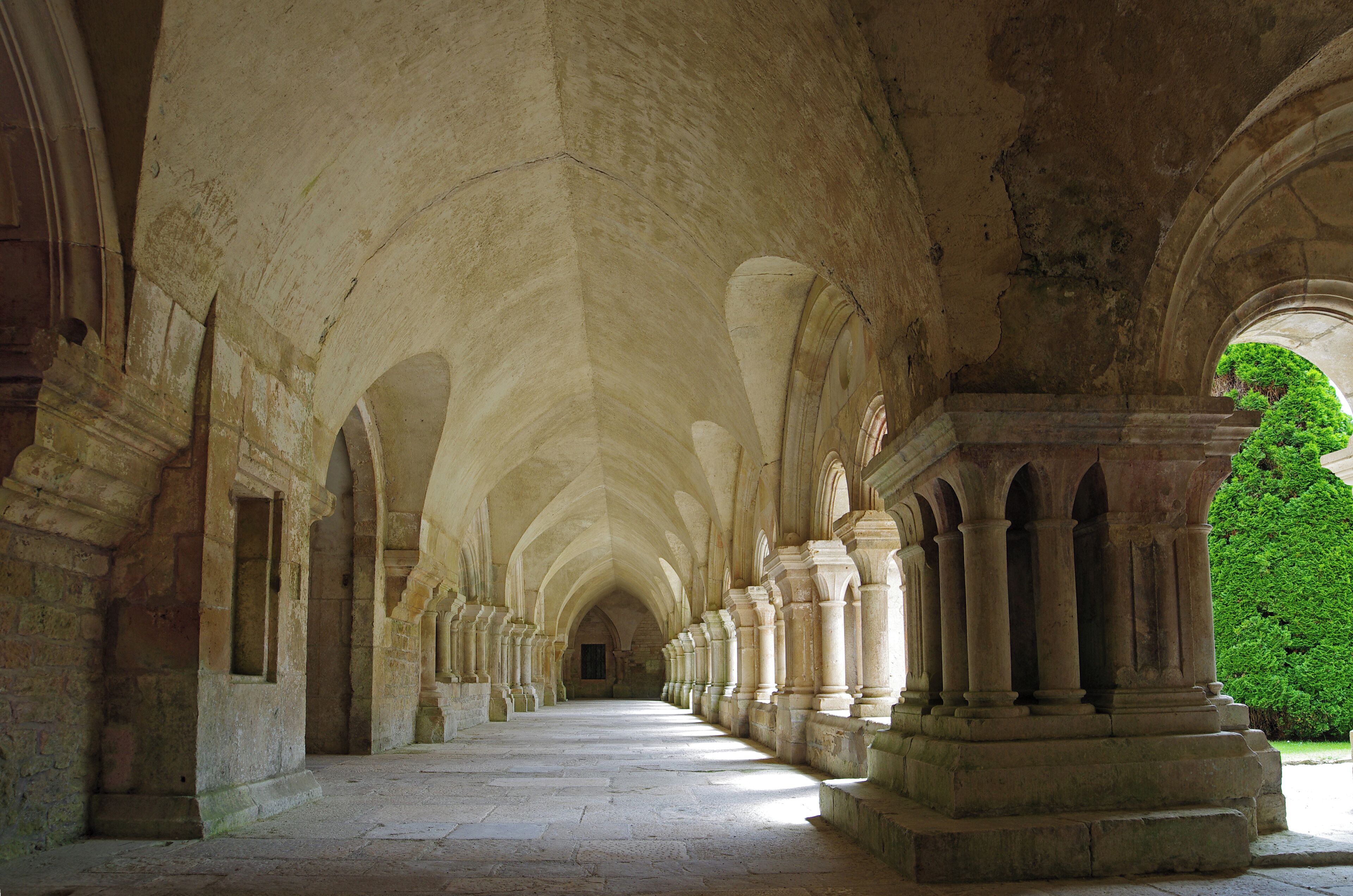 A long corridor with high, arched ceilings and columns.