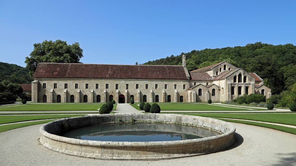 A historic building with a courtyard and a fountain.
