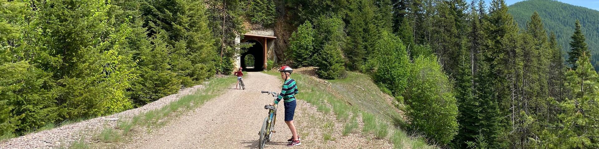 Boy and girl on bicycle trail called Route of the Hiawatha in northern Idaho (part of the rails to trails system)
