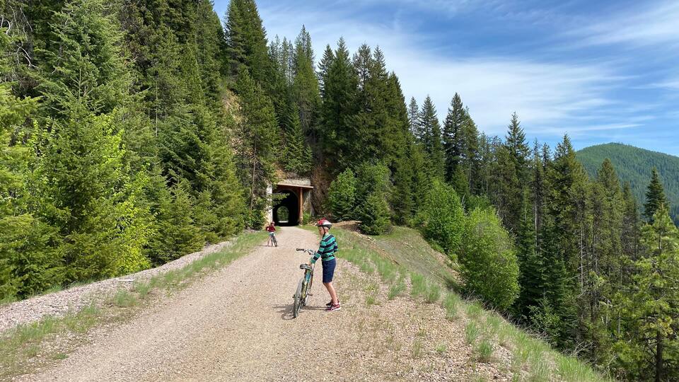 Boy and girl on bicycle trail called Route of the Hiawatha in northern Idaho (part of the rails to trails system)