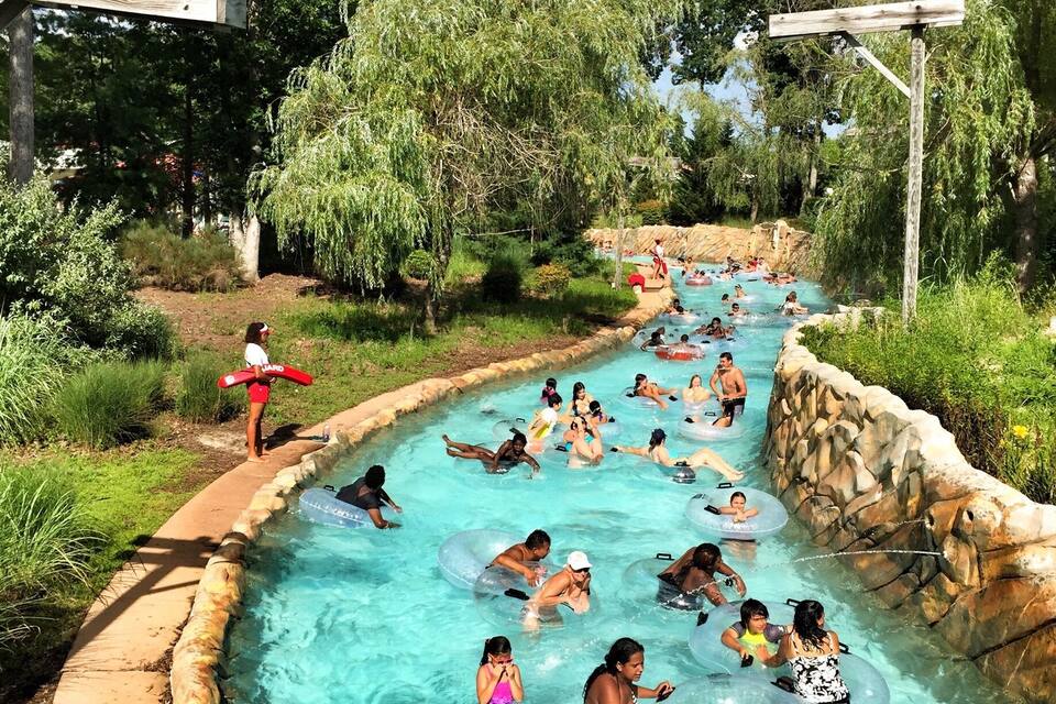 A water slide with people in inflatable tubes.