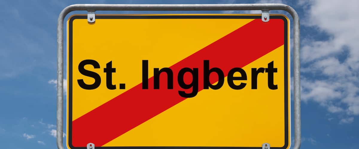 A road sign with the text "St. Ingbert" against a blue sky with clouds.