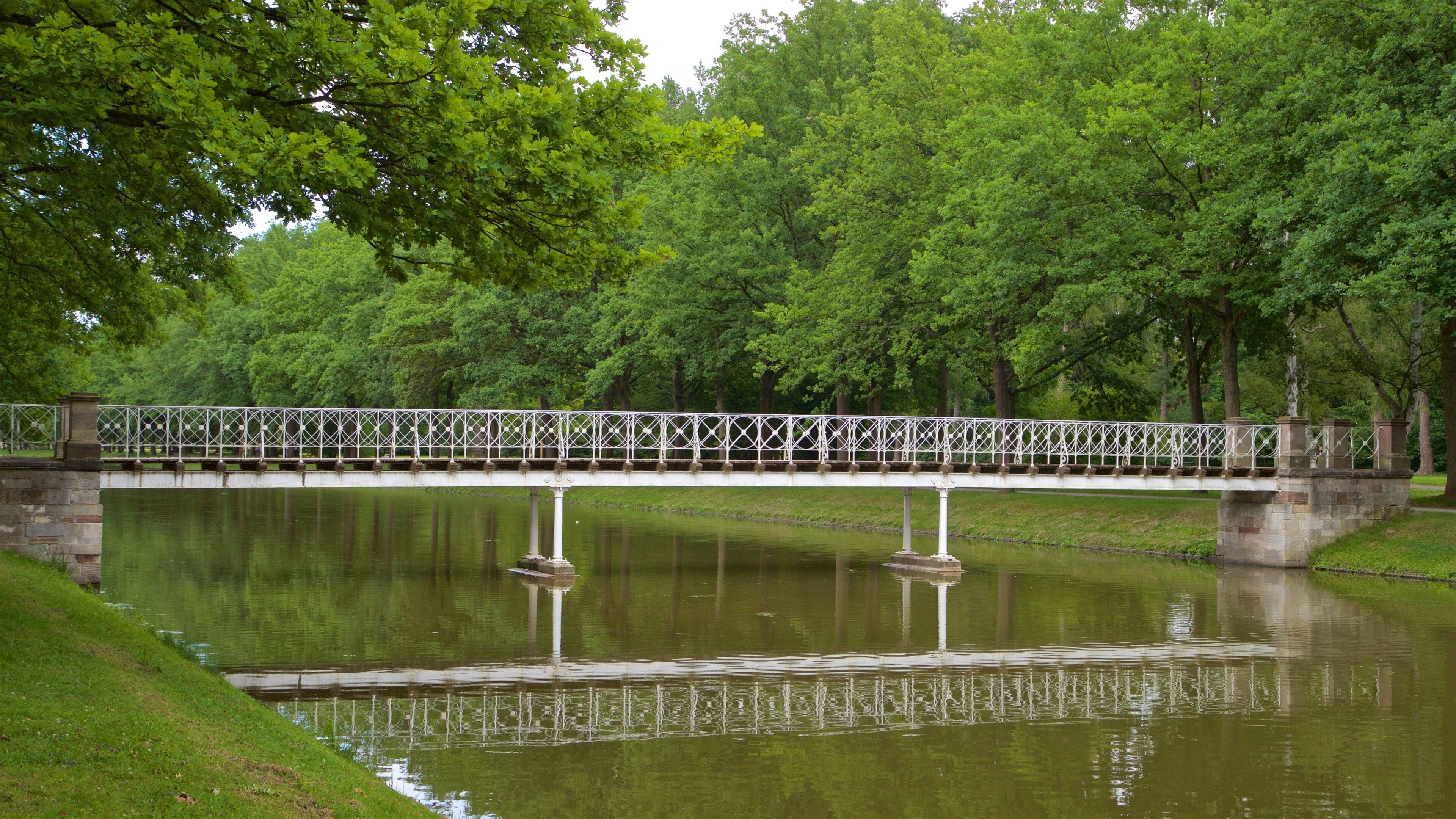Karlsaue Park which includes a bridge and a river or creek