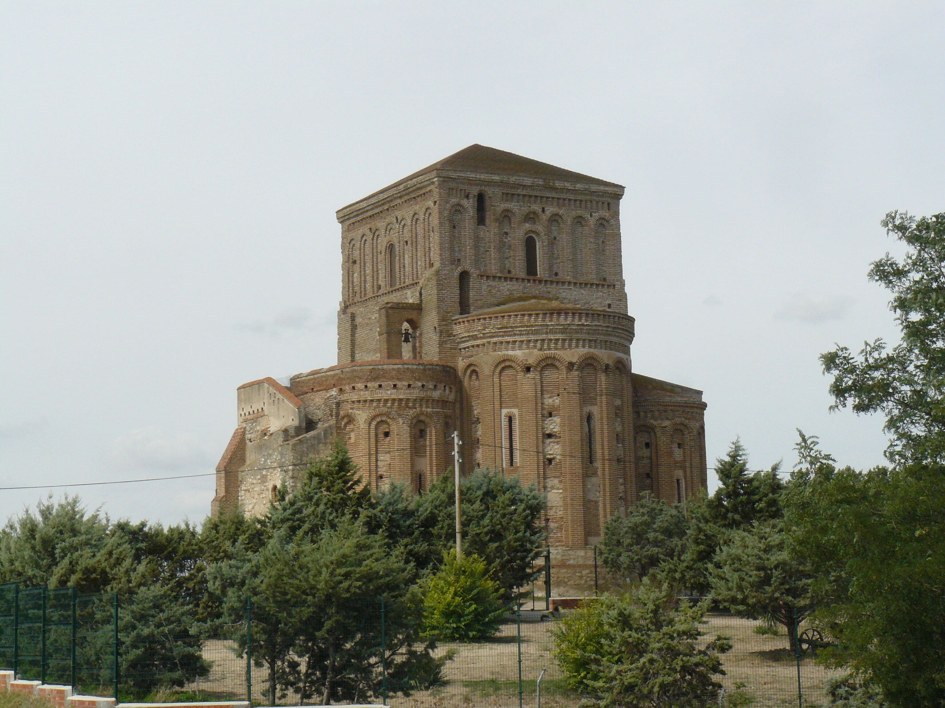 A historic church with a prominent bell tower and intricate brickwork.