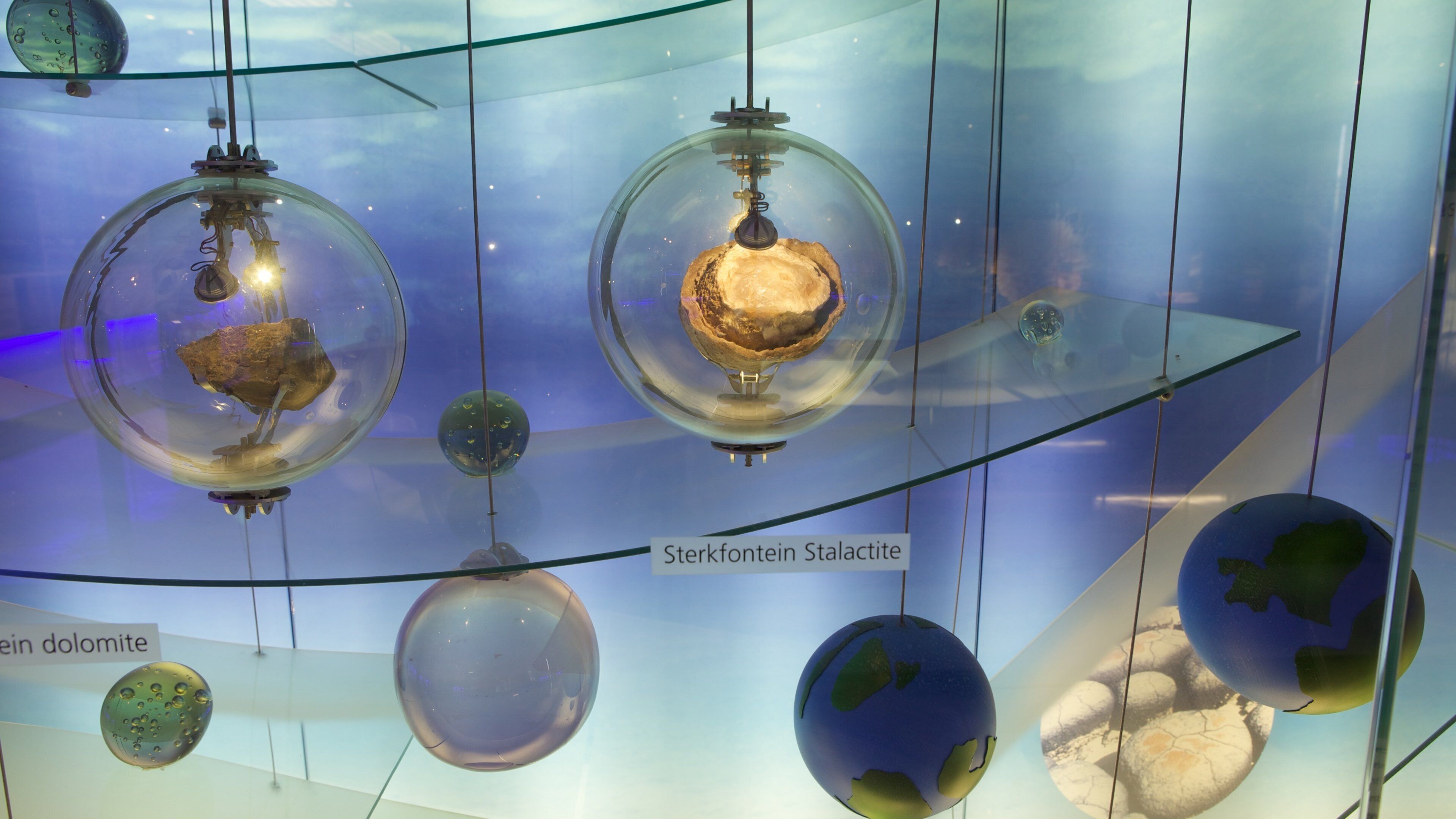 A display of spherical objects, including a labeled 'Sterkfontein Stalactite' and a 'ein dolomite'.