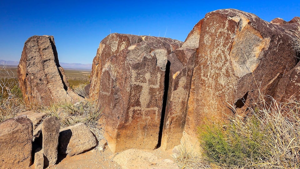 A rocky landscape with prominent rock formations and sparse vegetation.