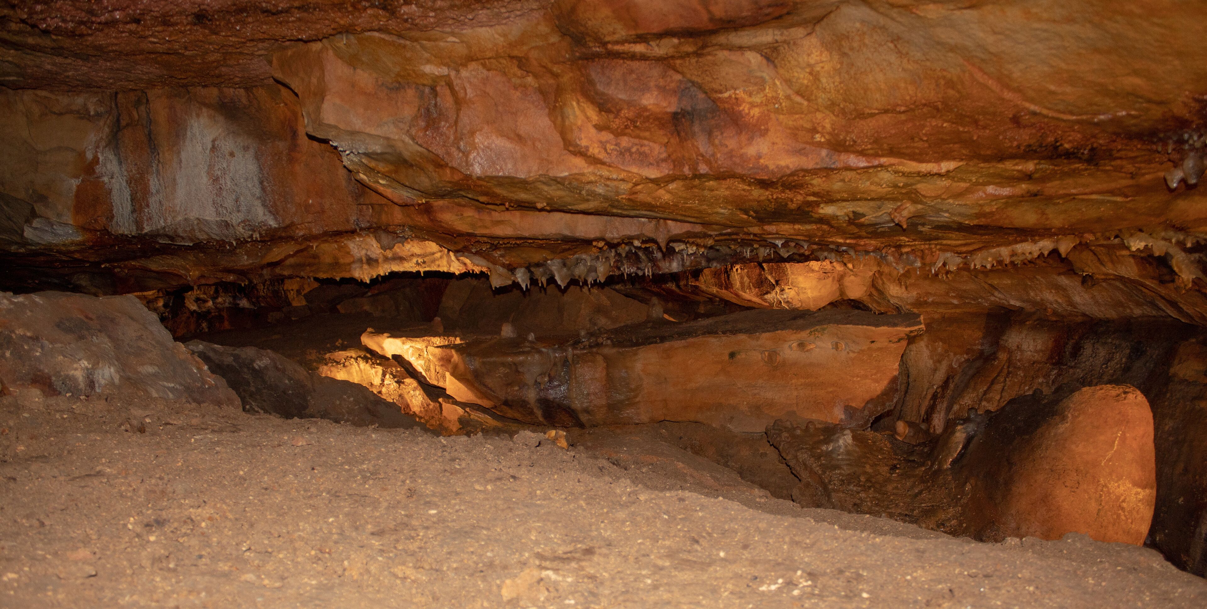 A cave interior with stalactites and stalagmites.