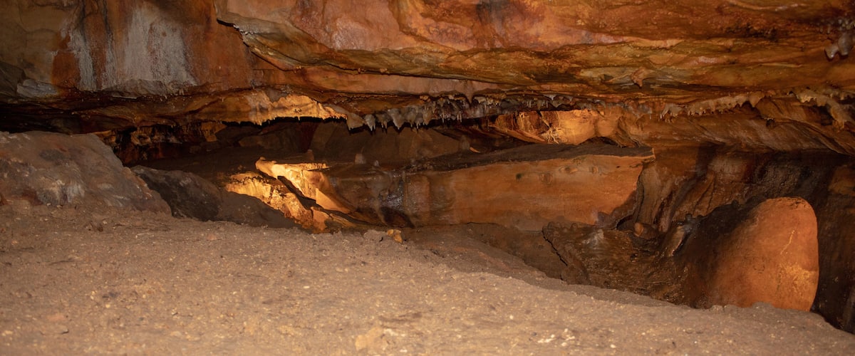 A cave interior with stalactites and stalagmites.