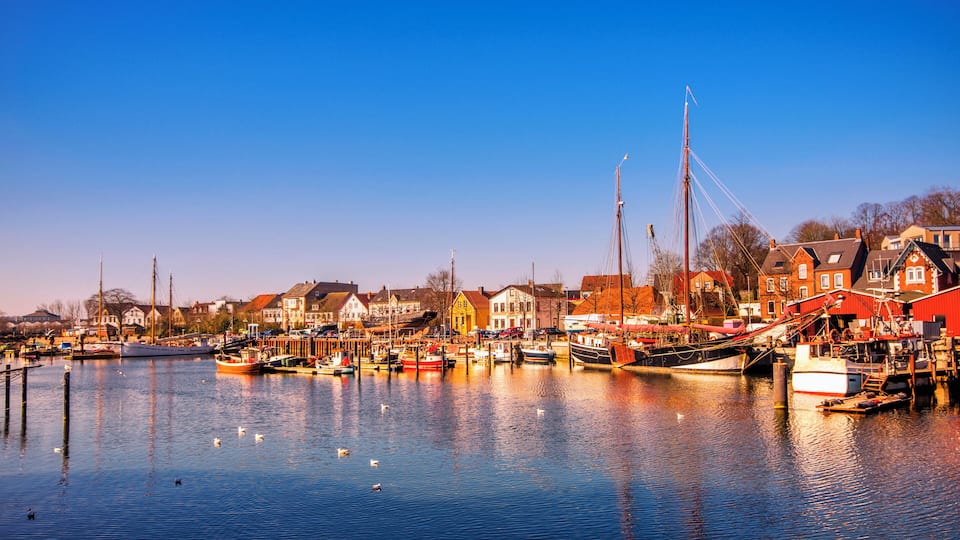 View on the old harbour and waterfront of Eckernförde in warm light.