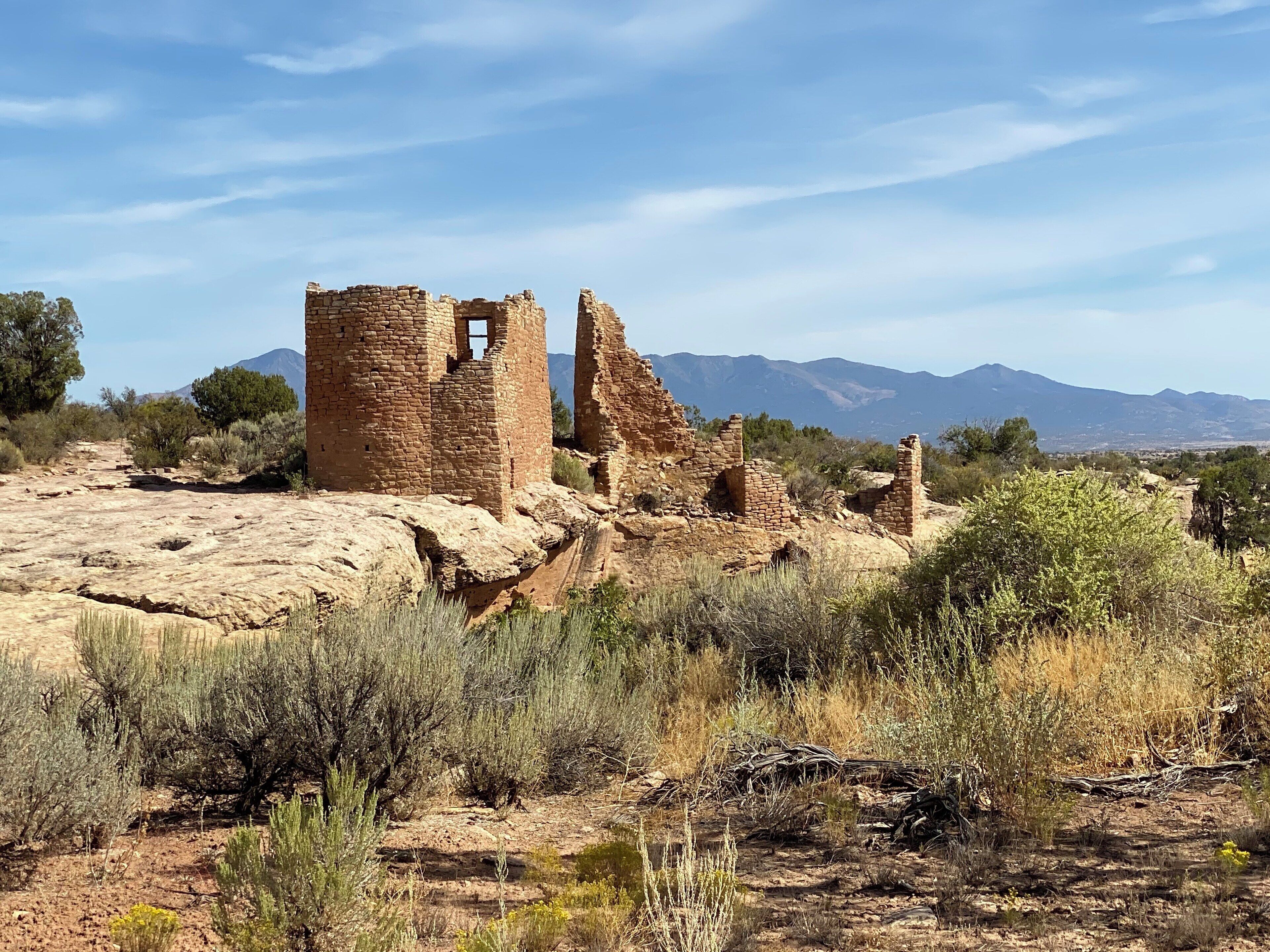 Ancient ruins with a mountainous backdrop.