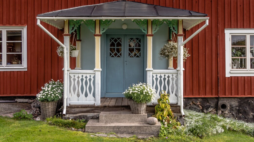 With flowers decorated facade Rof a ed cottage on the island Harstena in Sweden