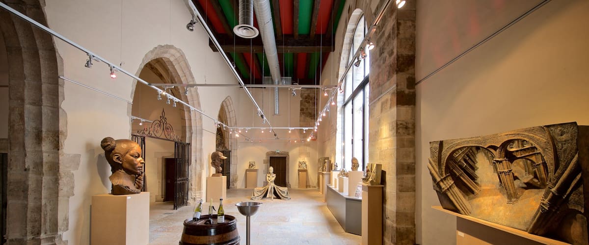 Marche Aux Vins Winery which includes interior views, a statue or sculpture and art