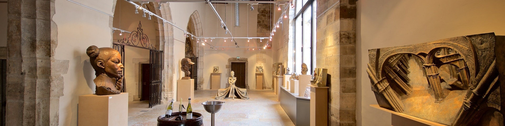 Marche Aux Vins Winery which includes interior views, a statue or sculpture and art