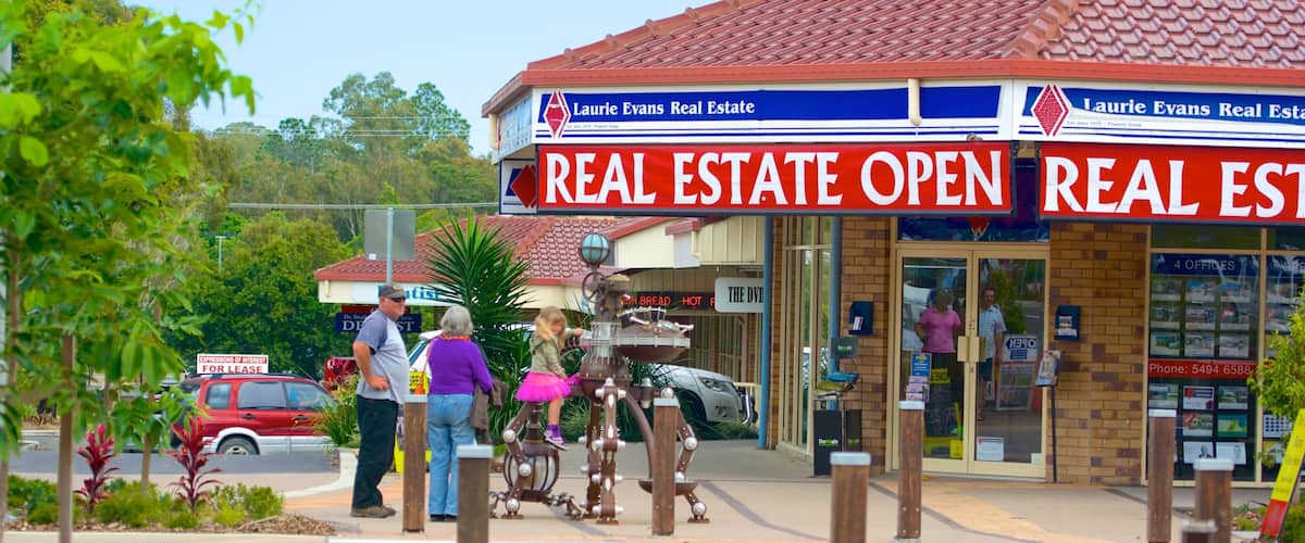 A real estate office named Laurie Evans Real Estate with a red and blue signboard.
