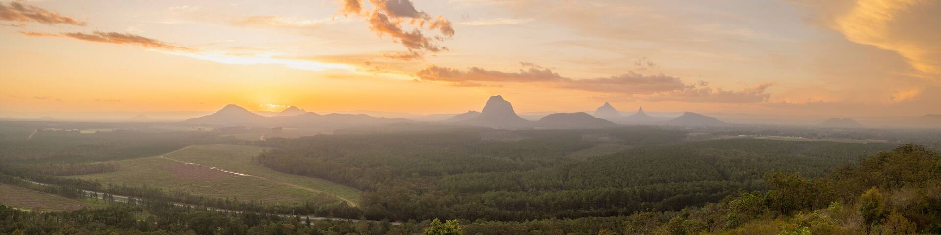 Tourists visit the Wildhorse scenic lookout for sunset panoramic views across the Glasshouse Mountains and the Sunshine Coast in Queensland