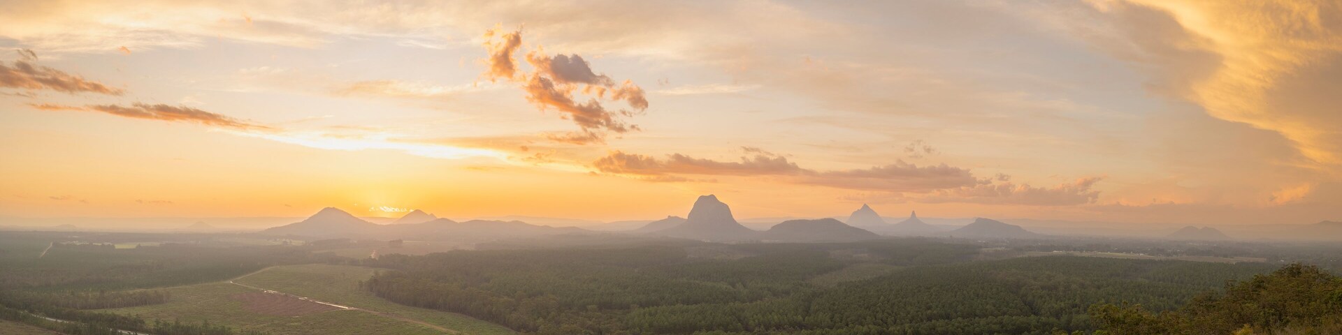 Tourists visit the Wildhorse scenic lookout for sunset panoramic views across the Glasshouse Mountains and the Sunshine Coast in Queensland
