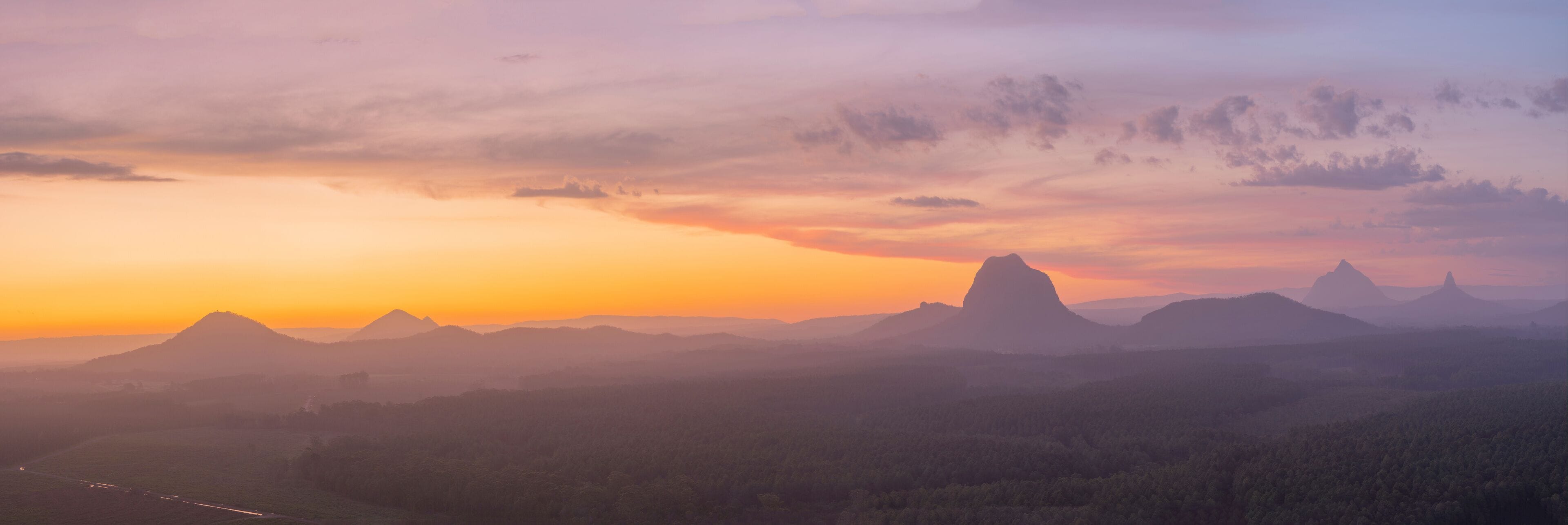 A mountain range at sunset with a clear sky.