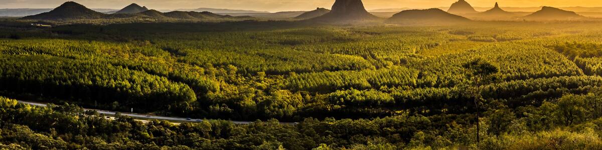 Panoramic view of Glass House Mountains at sunset visible from Wild Horse Mountain