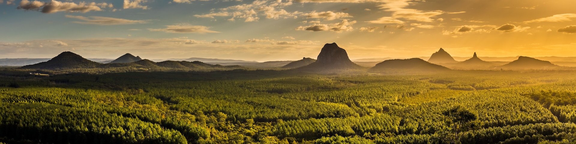 Panoramic view of Glass House Mountains at sunset visible from Wild Horse Mountain
