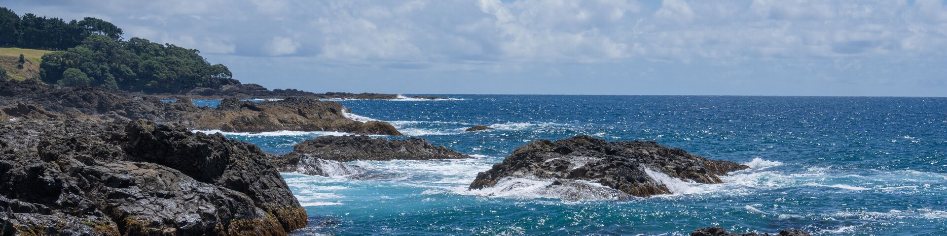 Rugged rocky coastline and view to horizon on east coast of Bay Of Plenty, New Zealand at Te Kaha.