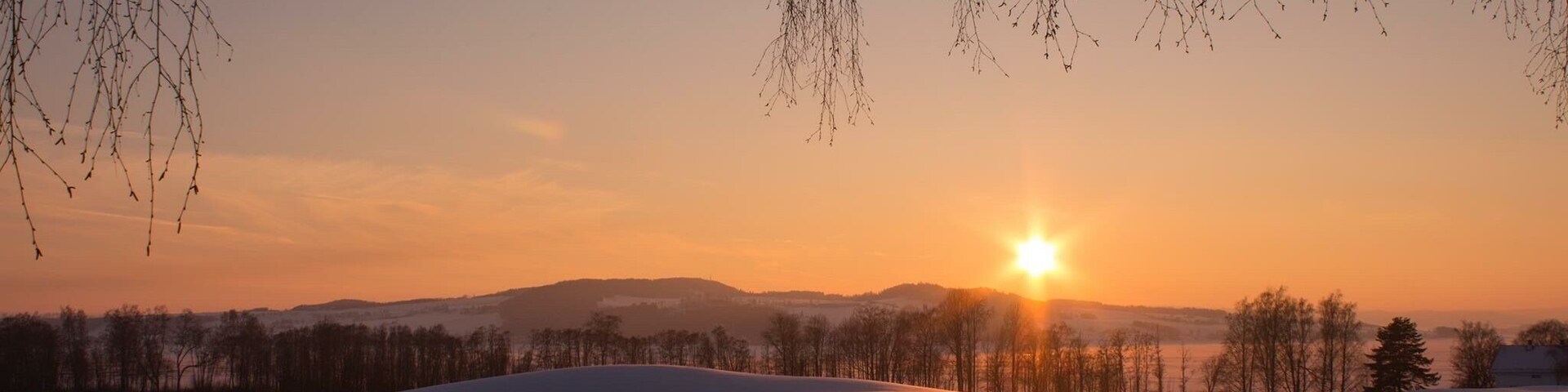 The sunset is coloring the snow