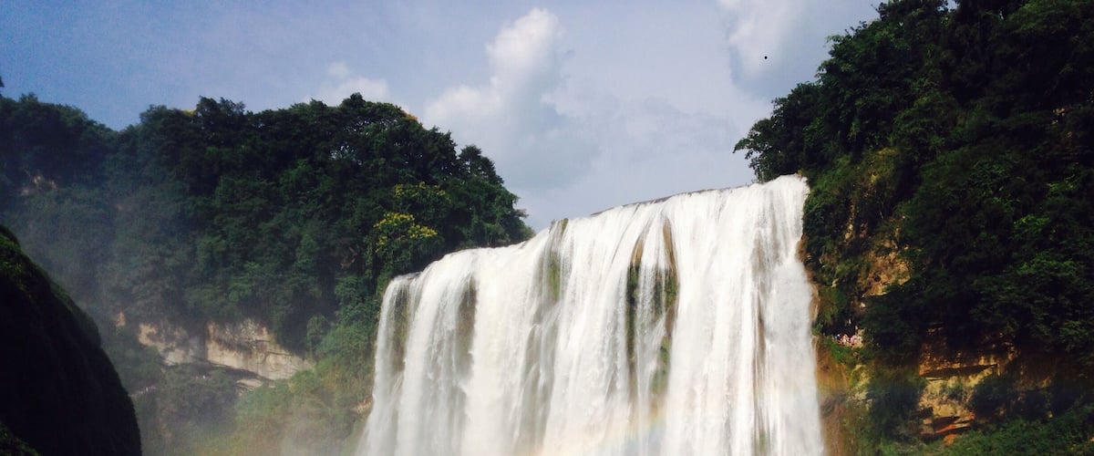 A waterfall with a rainbow.