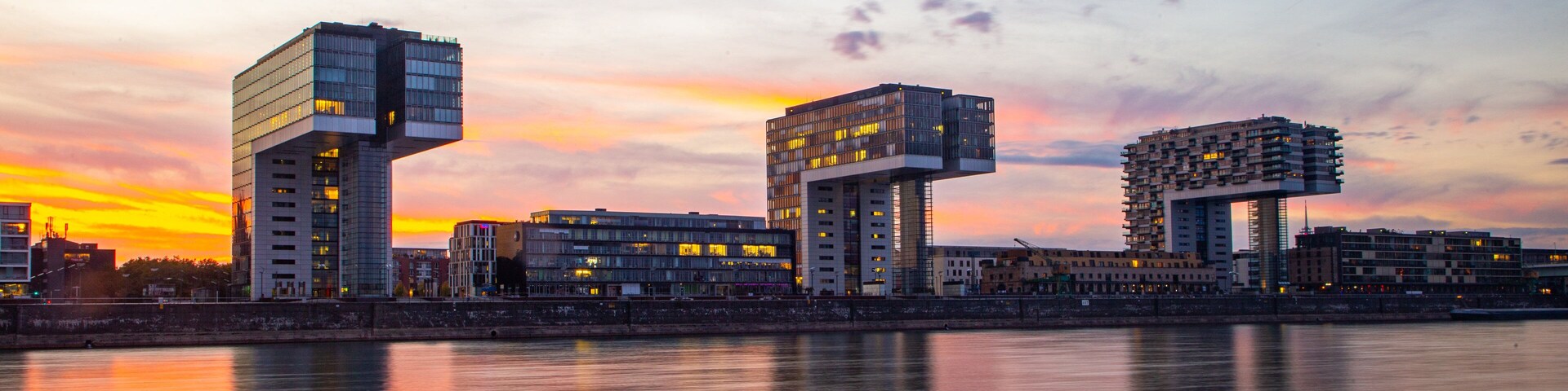 Rheinau Harbour showing a river or creek, a sunset and modern architecture