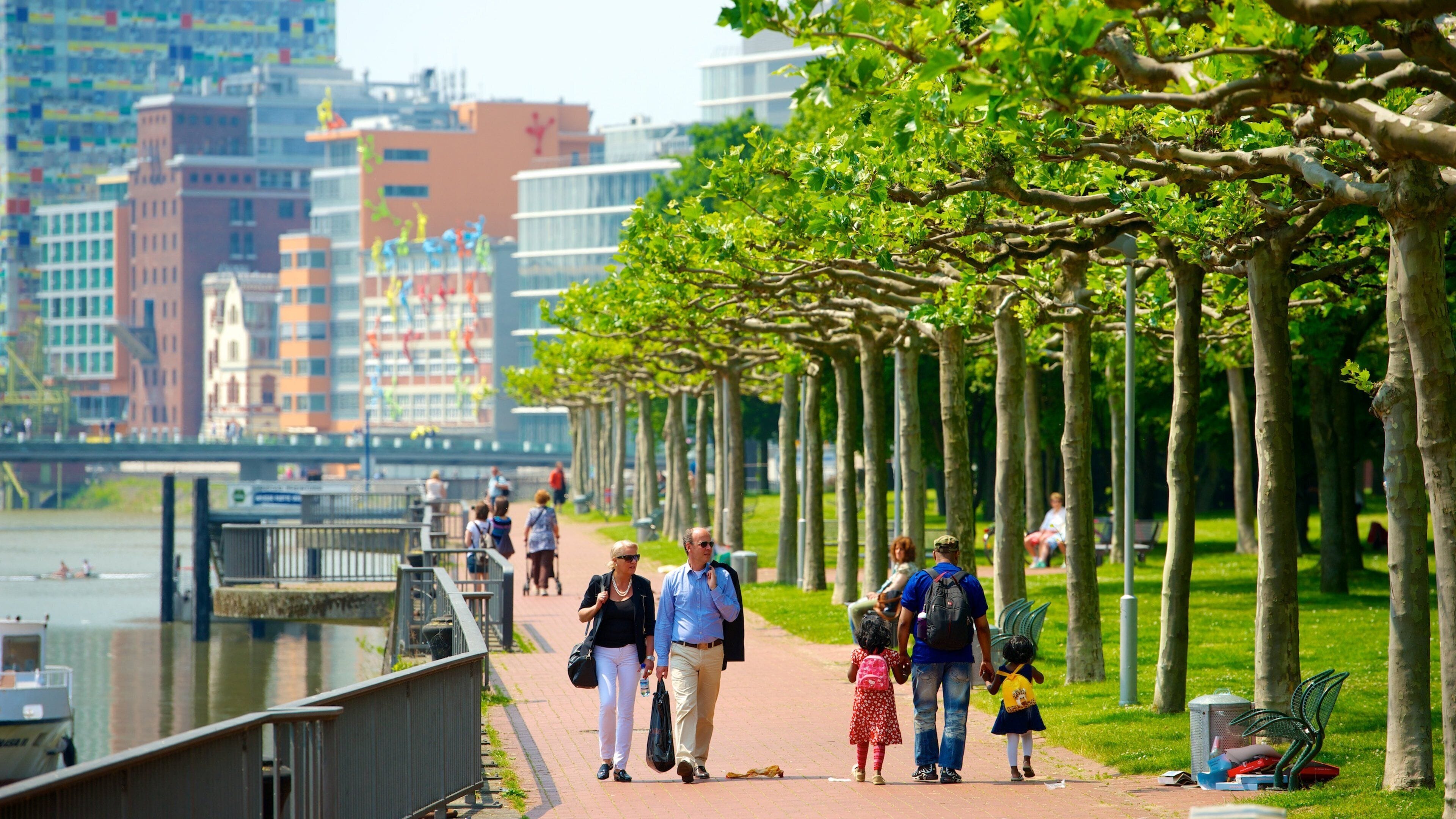 Dusseldorf-Hafen showing a city and a bay or harbor as well as a small group of people