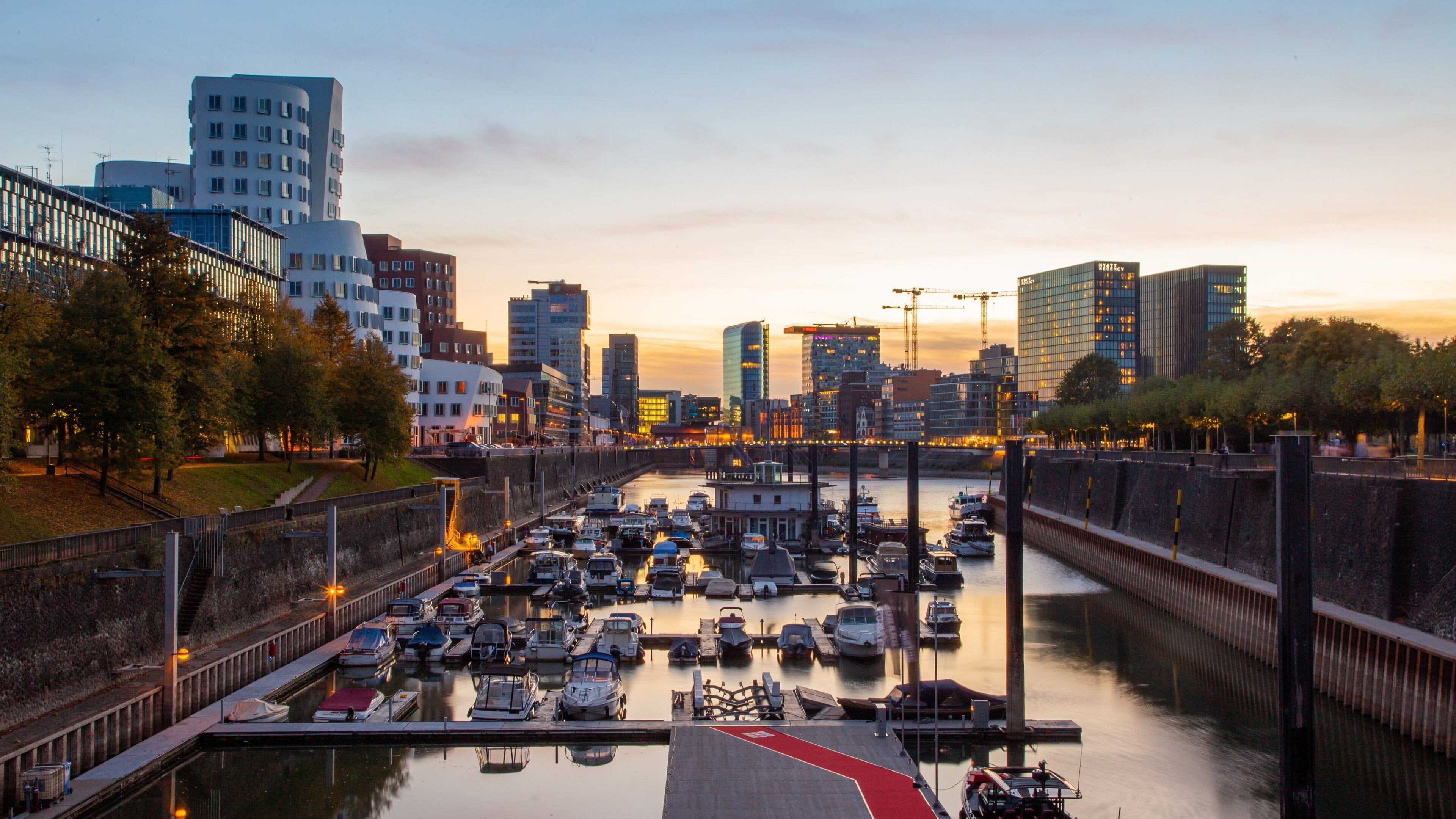 Duesseldorf-Hafen showing a bay or harbor, a city and a sunset