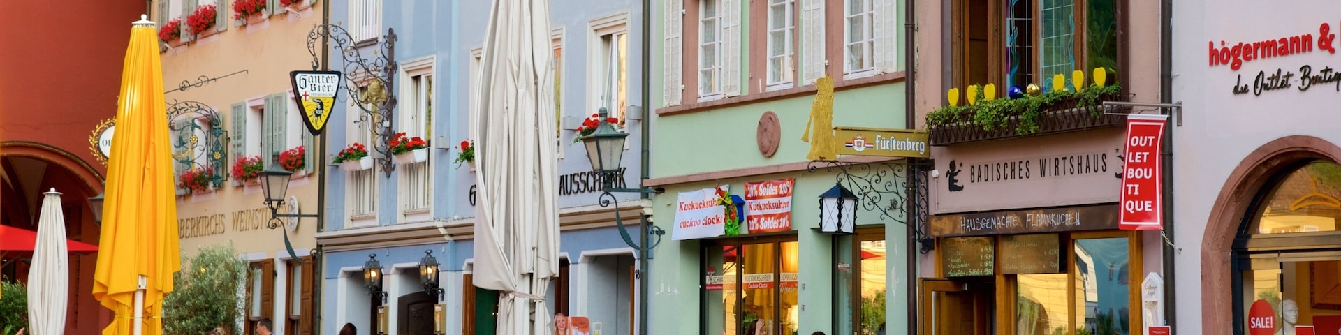 A bustling outdoor café with people dining and socializing.