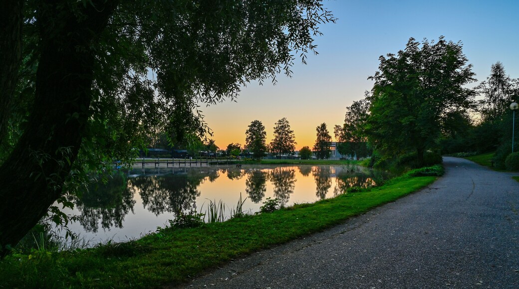 sunset over calm pond in silent park