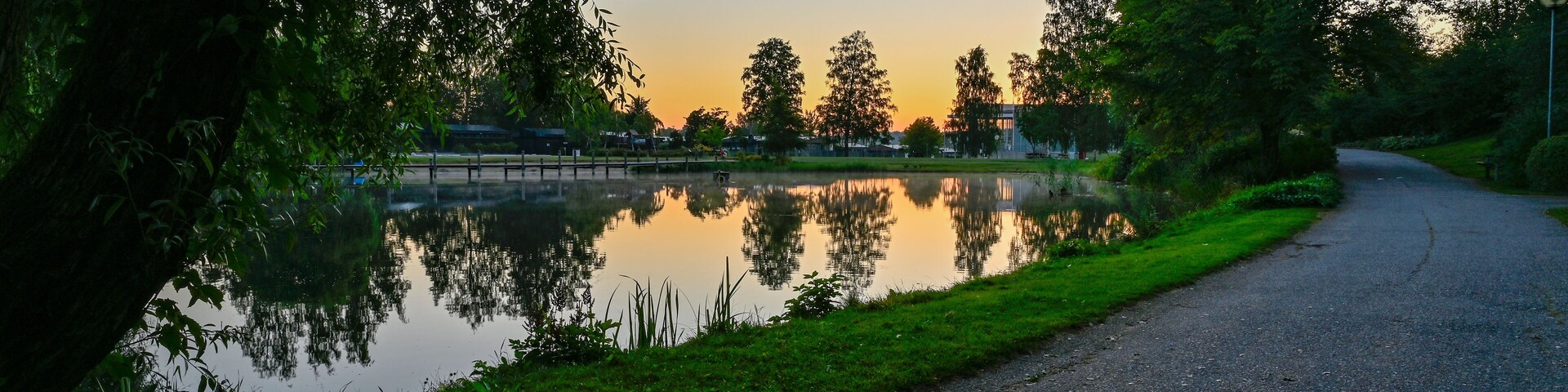 sunset over calm pond in silent park