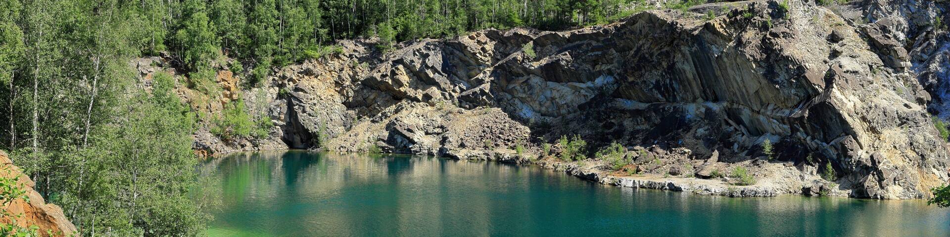 Limestone quarry lake with turquoise water. Summer day in Uskavi, Nora, Bergslagen, Sweden.