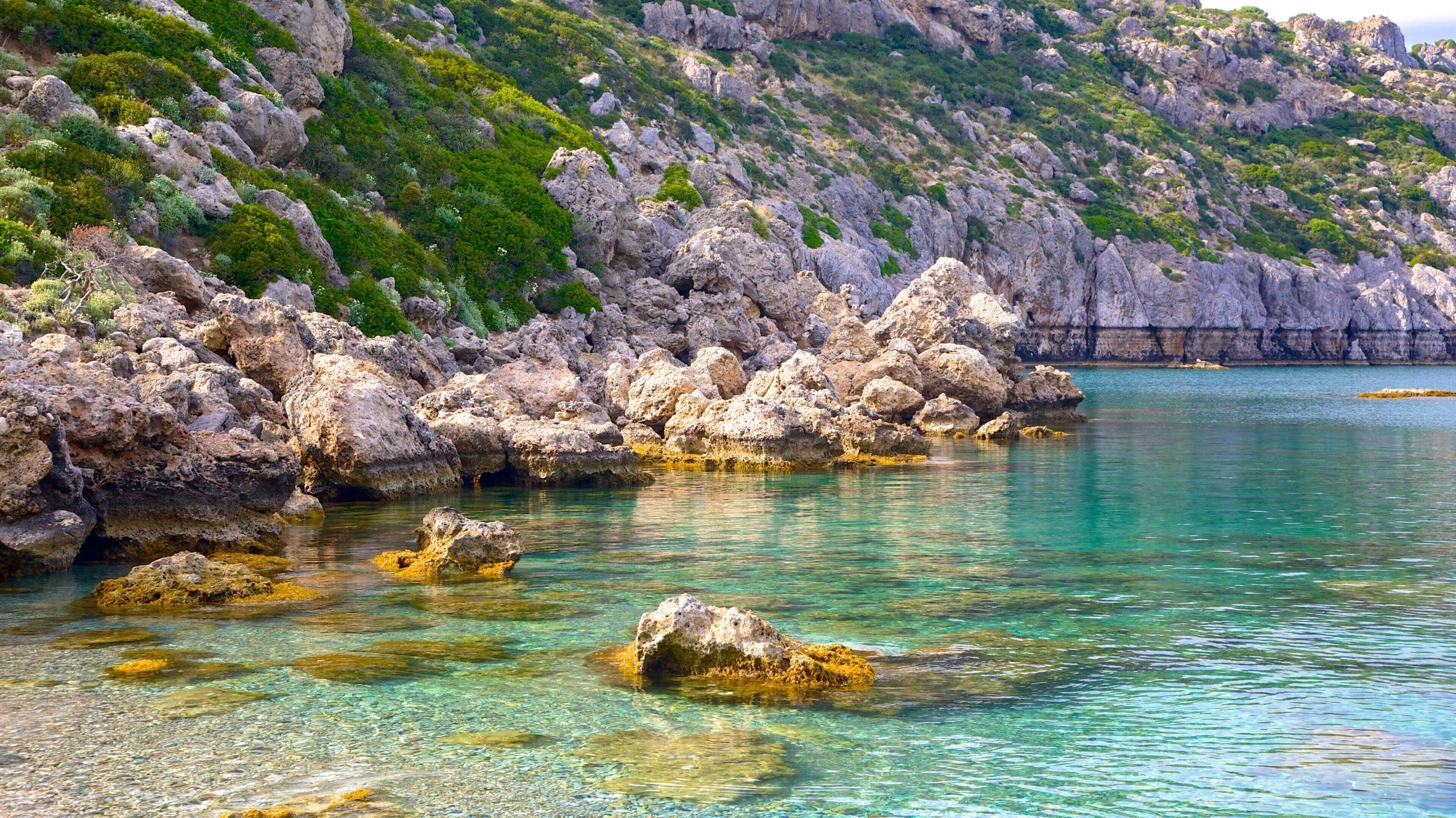Anthony Quinn Bay which includes rugged coastline