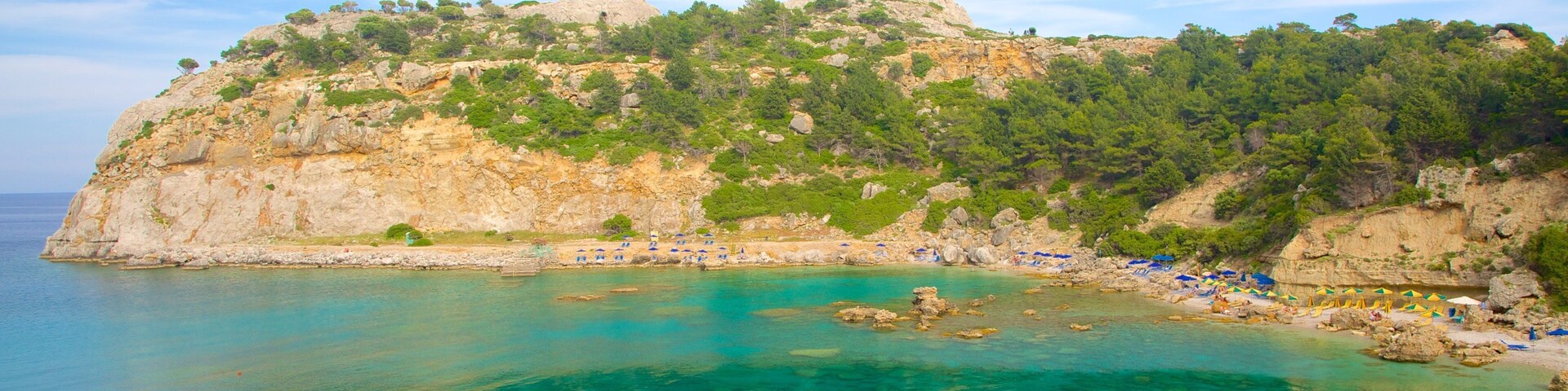 Anthony Quinn Bay which includes rocky coastline