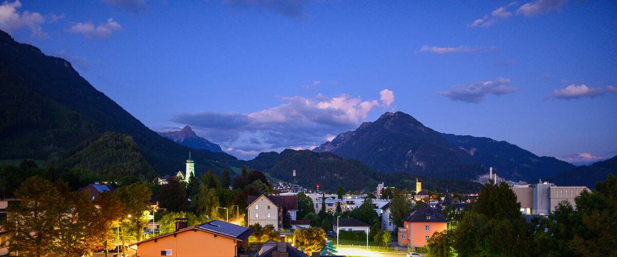 A town nestled in a valley with mountains in the background.