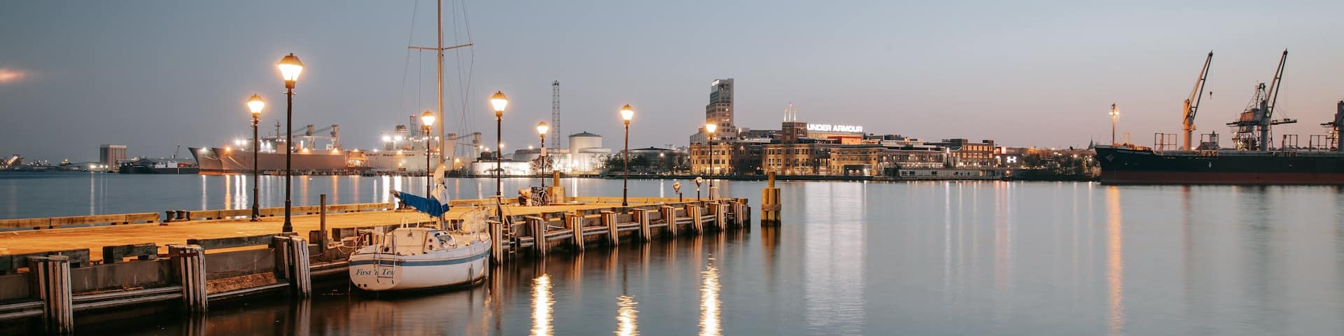 Fells Point which includes a marina and a sunset
