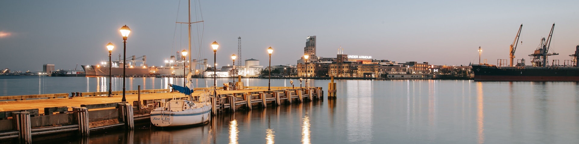 Fells Point which includes a marina and a sunset
