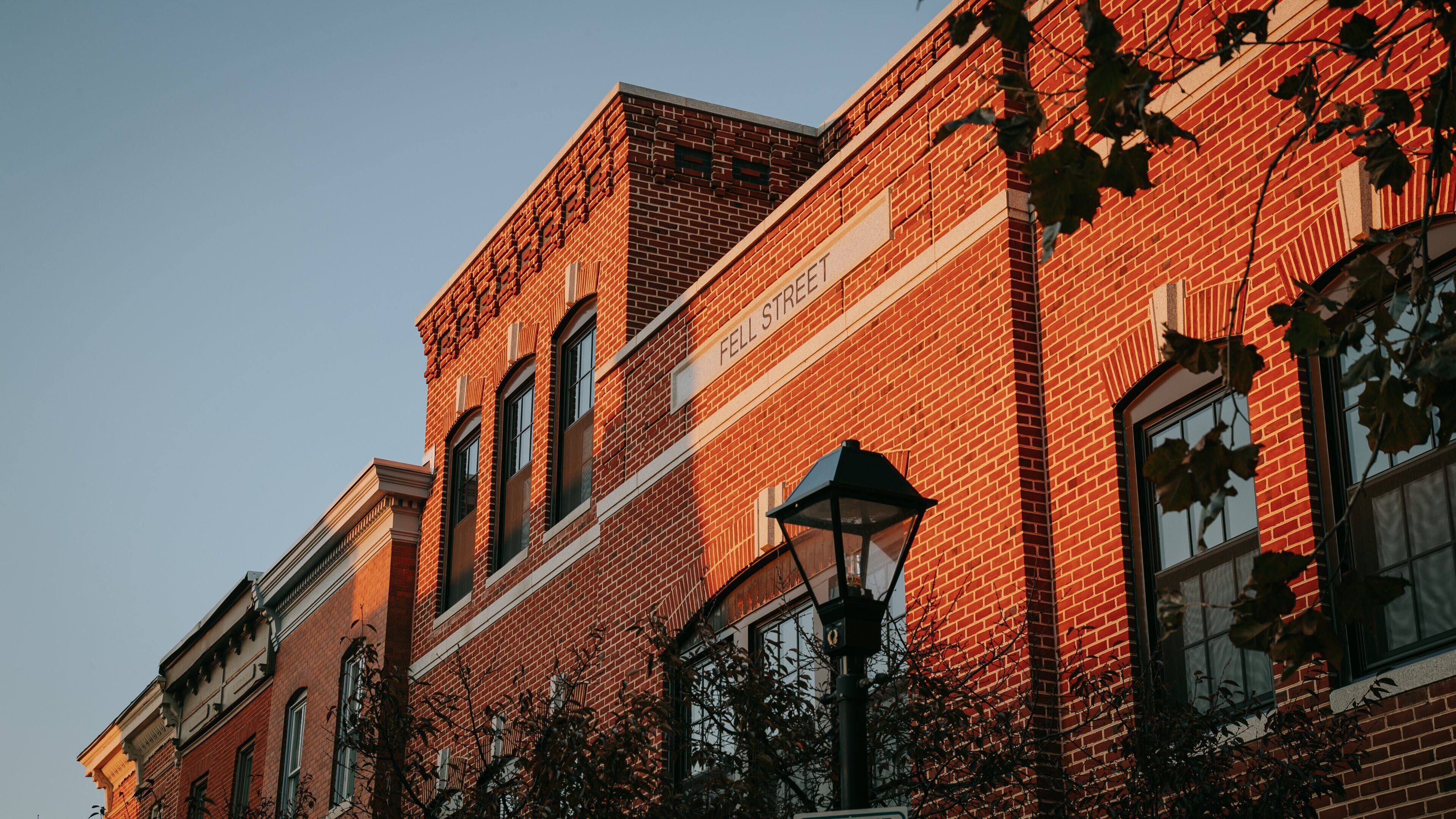 A red brick building with a sign that reads "Fell Street."
