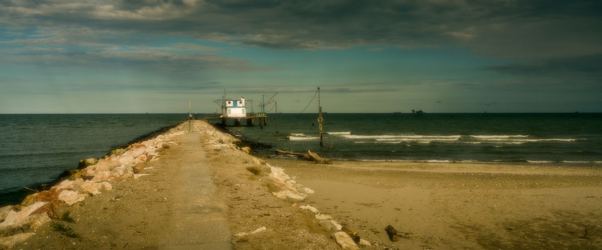 A coastal walkway leading to a lighthouse.