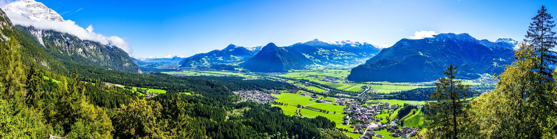 A mountainous landscape with a village nestled in the valley.