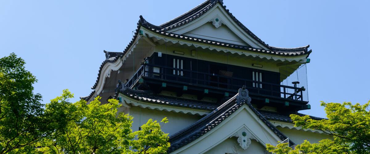 A traditional Japanese building with a multi-tiered roof and a balcony.